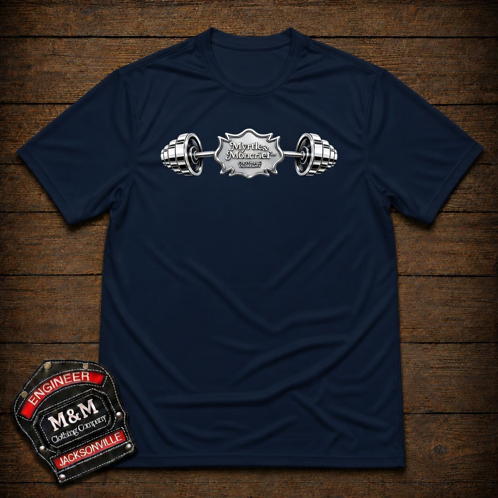 A navy blue short-sleeve t-shirt with a silver and white barbell graphic across the chest, displayed flat on a dark wood background. A matching embroidered patch is shown in the bottom-left corner.