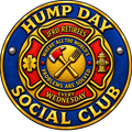 A circular novelty emblem or sign for the 'Hump Day Social Club' featuring a fire department Maltese cross design with red, gold, and blue sections, crossed axes, a small axe, a hydrant, and text including 'JFRD Retirees' and 'Where all the world's problems are solved every Wednesday'.