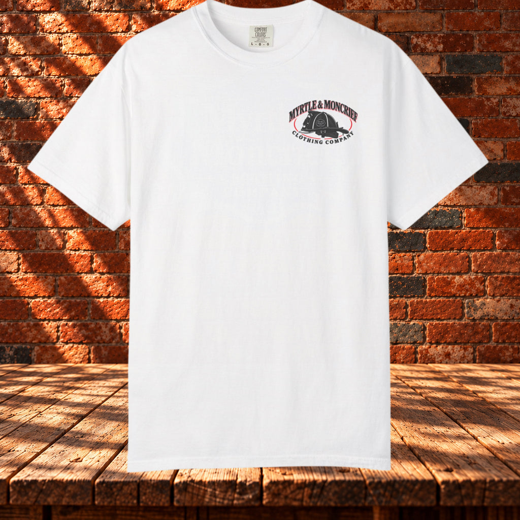 Front view: White crewneck T-shirt with a small Myrtle & Moncrief firefighter helmet logo on the left chest.